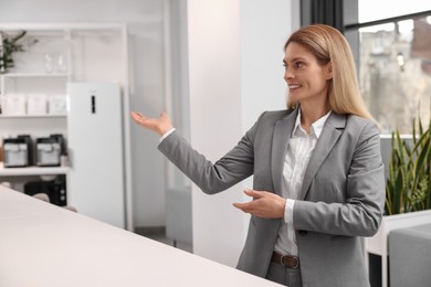 Happy female real estate agent in office