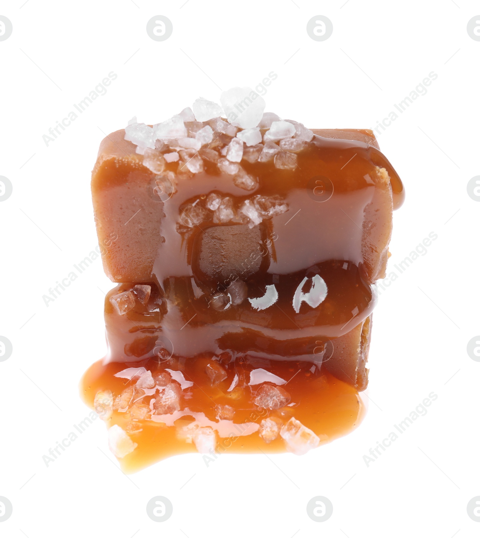 Photo of Delicious salted caramel with sauce on white background