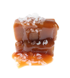 Photo of Delicious salted caramel with sauce on white background