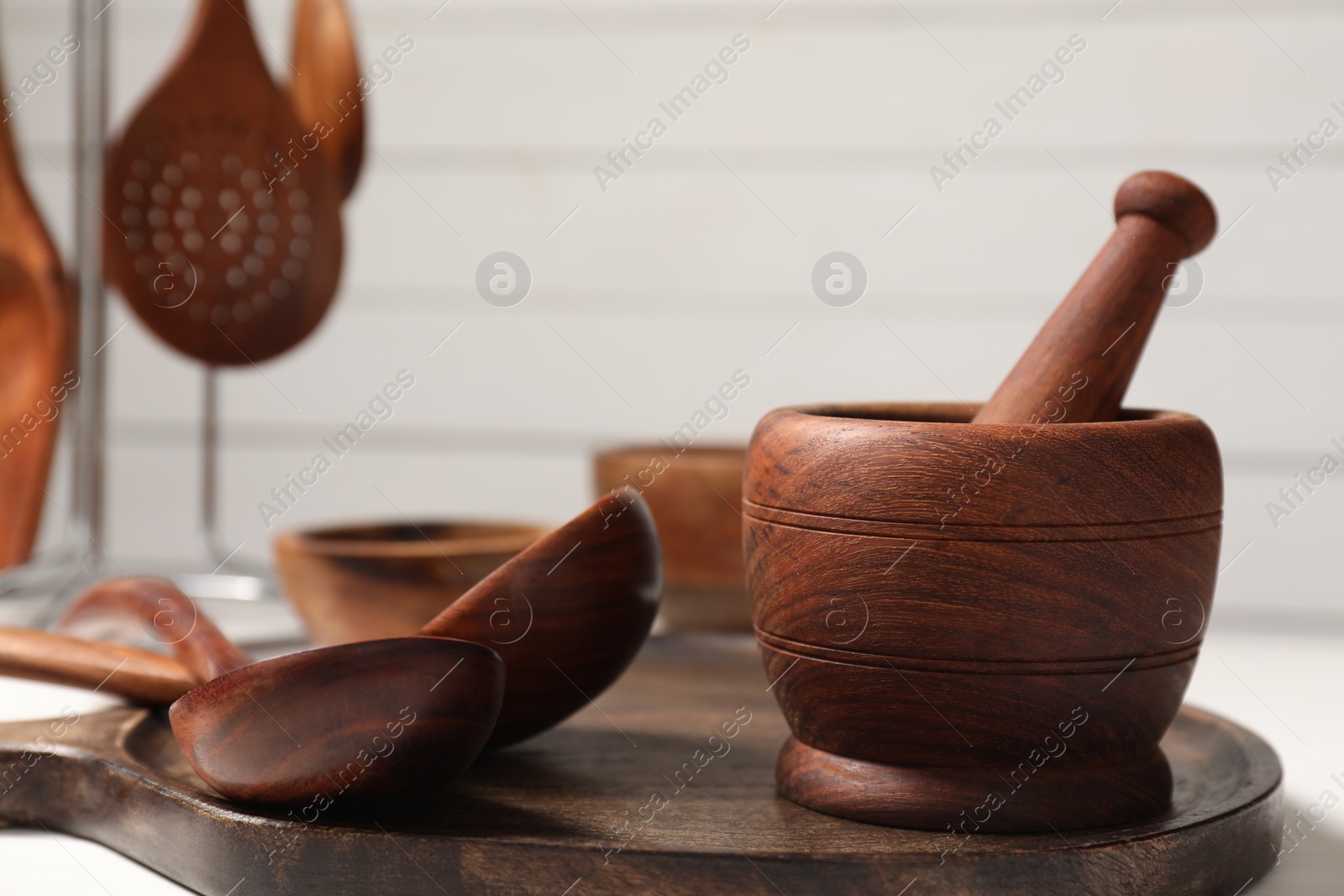 Photo of Set of different kitchen utensils on white table, closeup