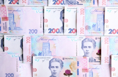 Photo of Ukrainian money as background, top view. National currency