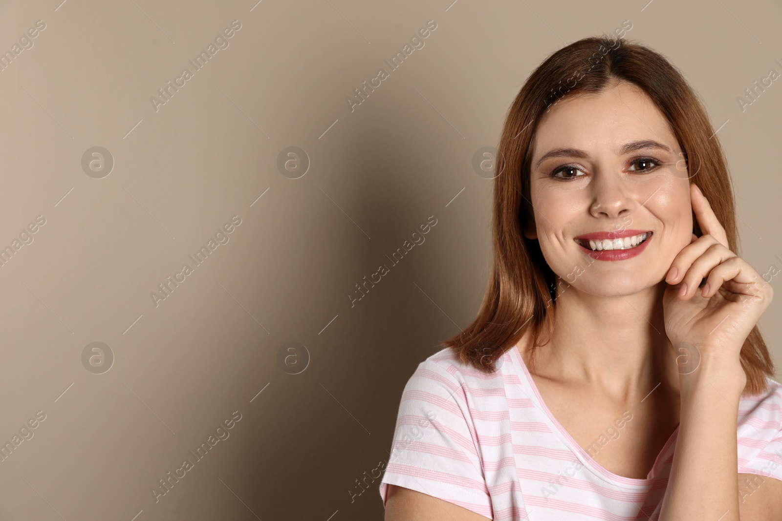 Photo of Smiling woman with perfect teeth on color background. Space for text