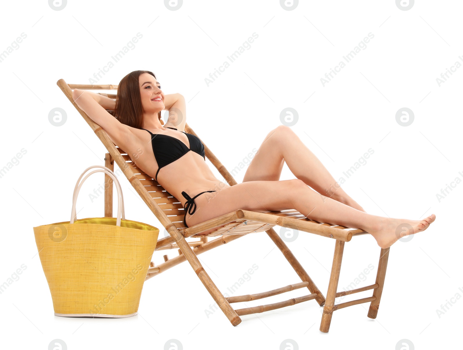 Photo of Young woman with bag on sun lounger against white background. Beach accessories