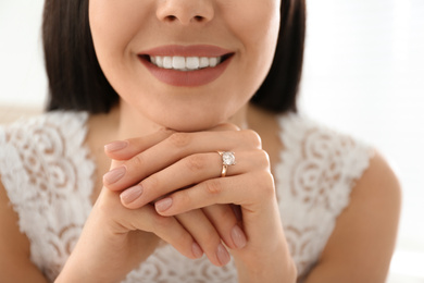 Photo of Young bride wearing beautiful engagement ring, closeup