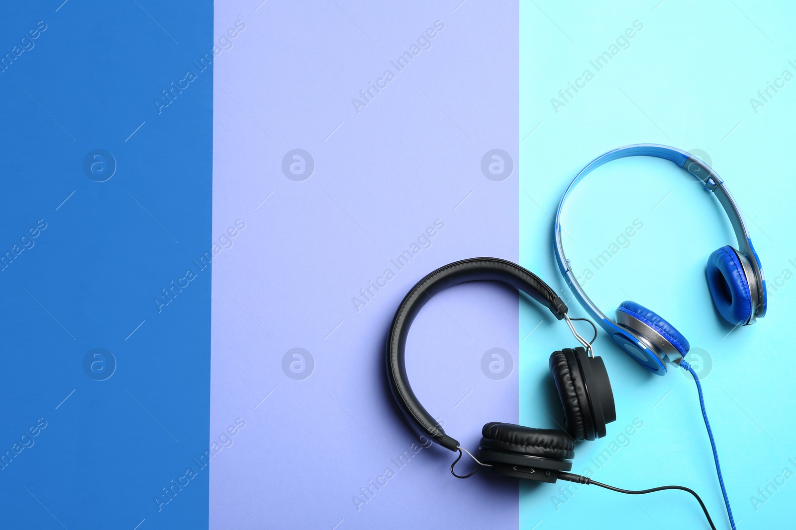 Photo of Stylish headphones on color background, flat lay. Space for text