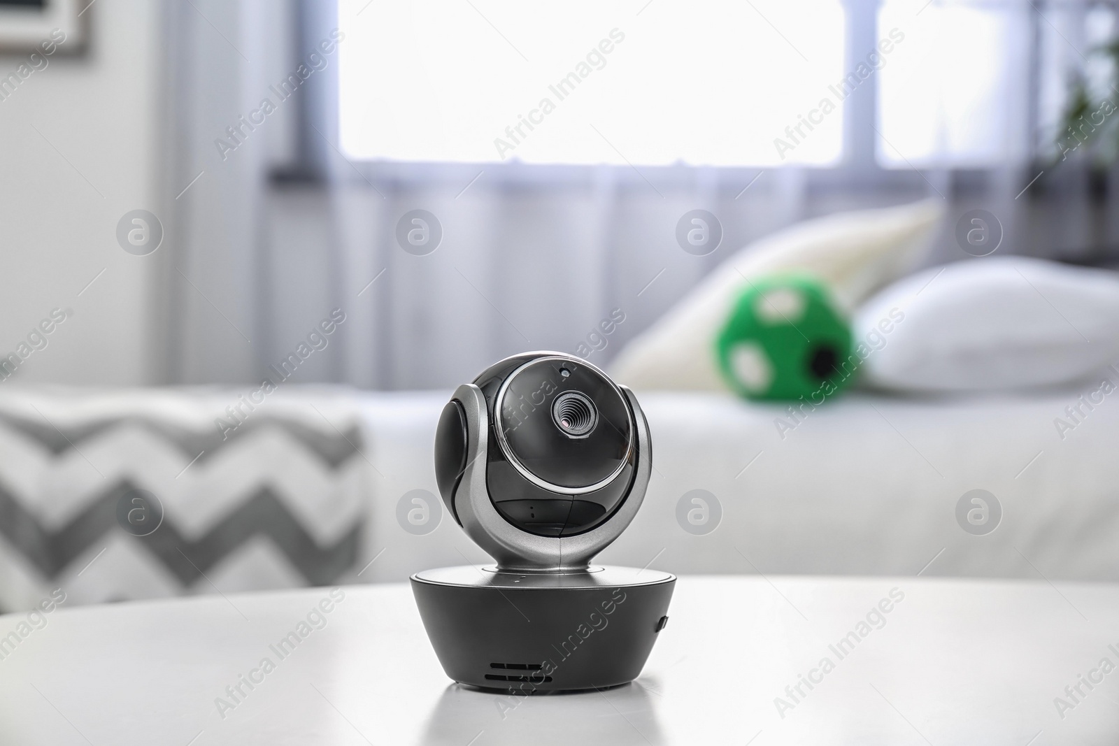 Photo of Baby monitor on table in room. CCTV equipment