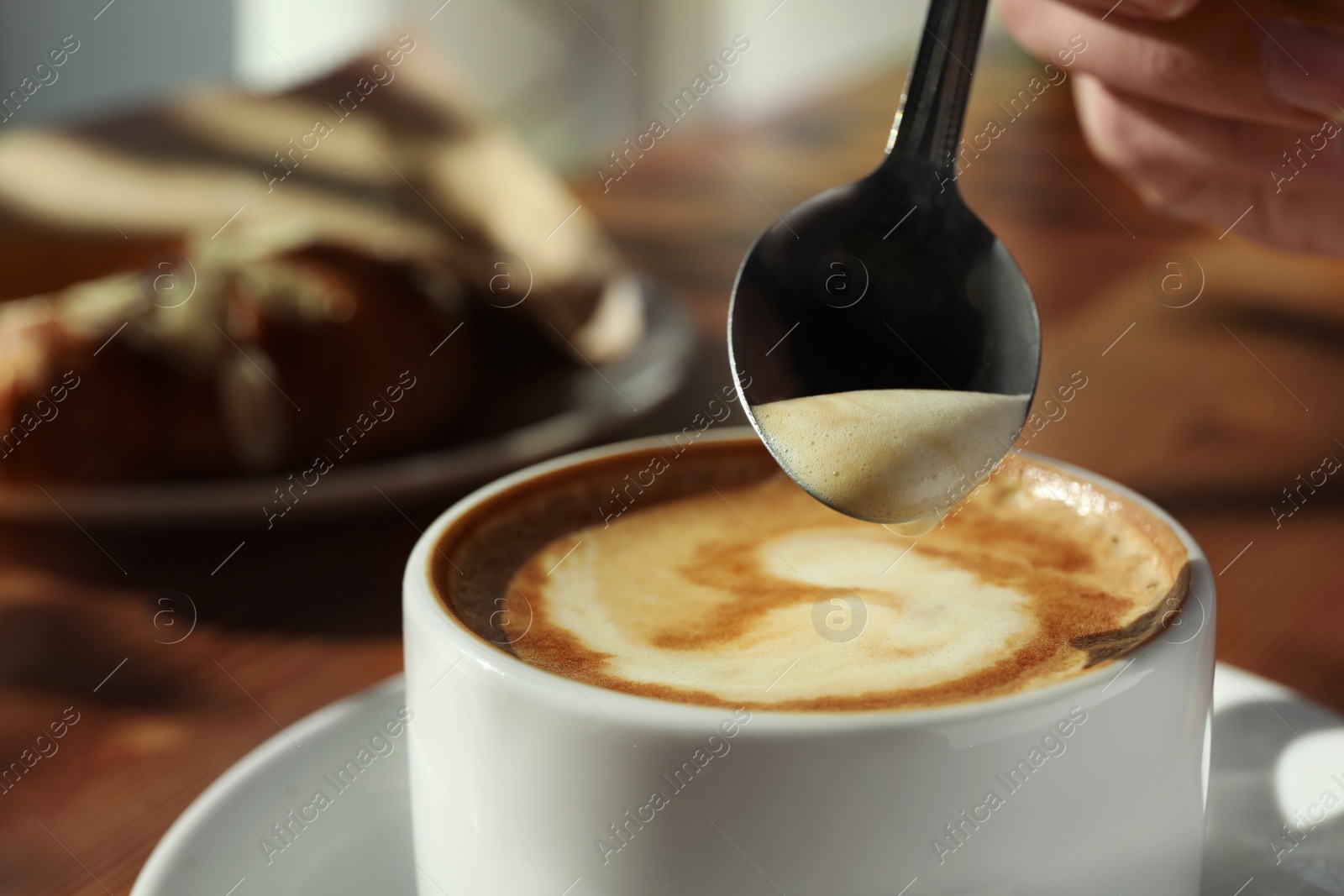 Photo of Cup of fresh aromatic coffee at table in cafe