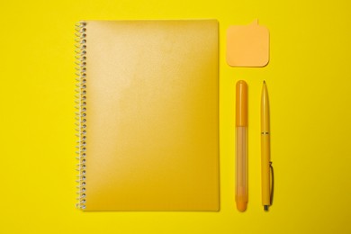Different school stationery on yellow background, flat lay