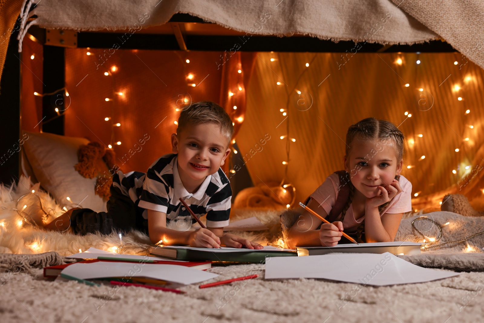 Photo of Children drawing in play tent at home