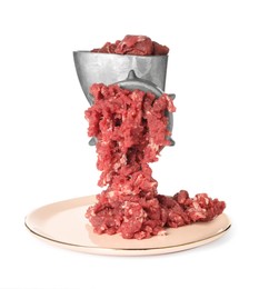 Photo of Metal meat grinder with minced beef and plate isolated on white