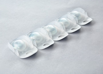 Packages with contact lenses on light background