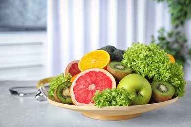 Photo of Plate of fruits on table. Diet plan from nutritionist