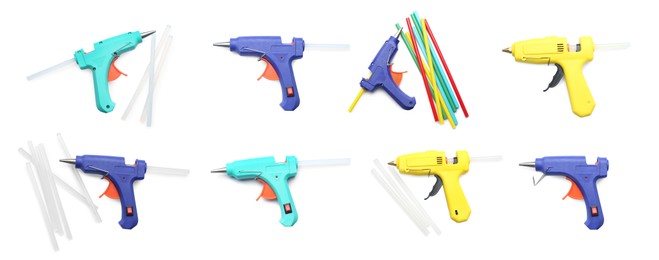 Set with different glue guns with sticks on white background, top view. Banner design