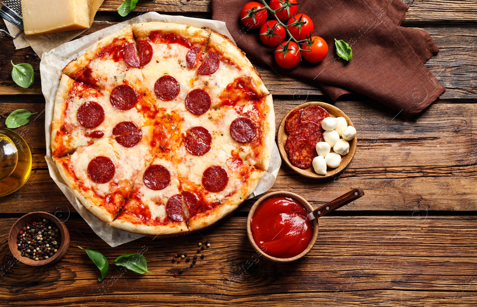 Photo of Flat lay composition with hot pepperoni pizza on wooden table