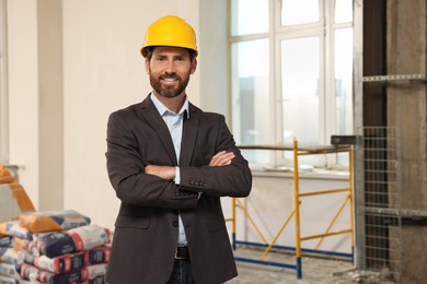 Photo of Portrait of professional engineer in hard hat indoors
