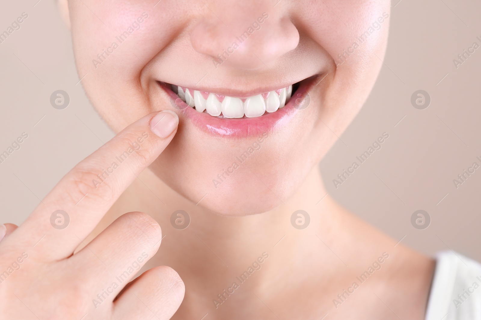Photo of Young woman with beautiful smile on color background, closeup