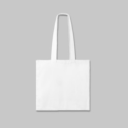 Image of White textile eco bag on light grey background. Mock up for design