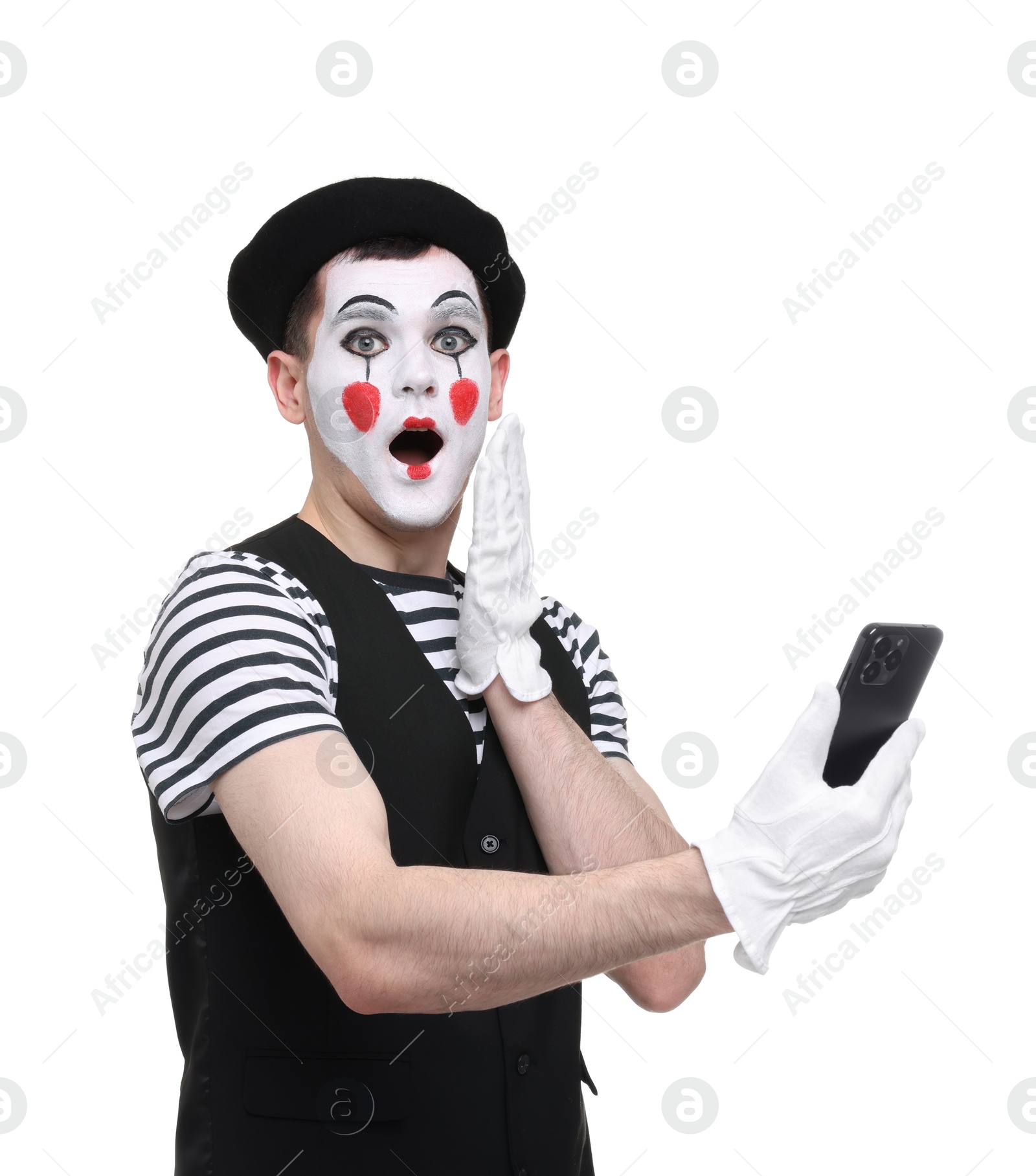 Photo of Mime artist with smartphone making shocked face on white background