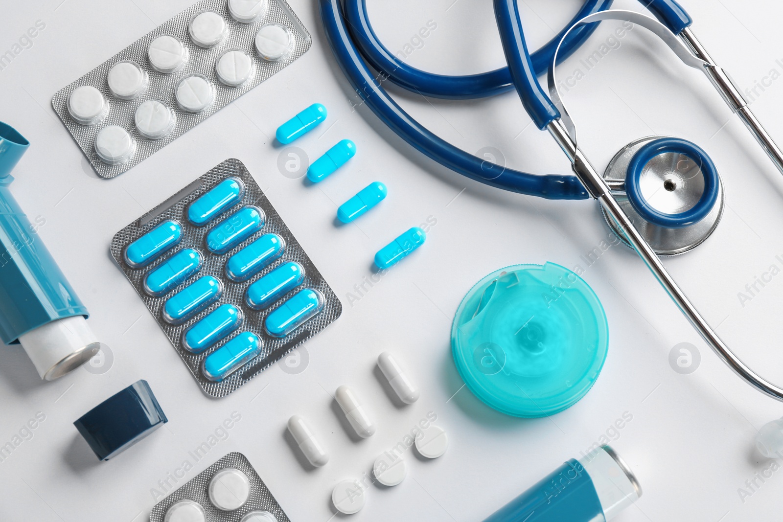 Photo of Flat lay composition with stethoscope and asthma medications on white background