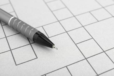 Pen on blank crossword, closeup. Space for text