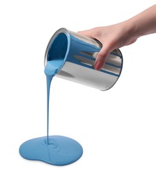Woman pouring light blue paint from can on white background, closeup
