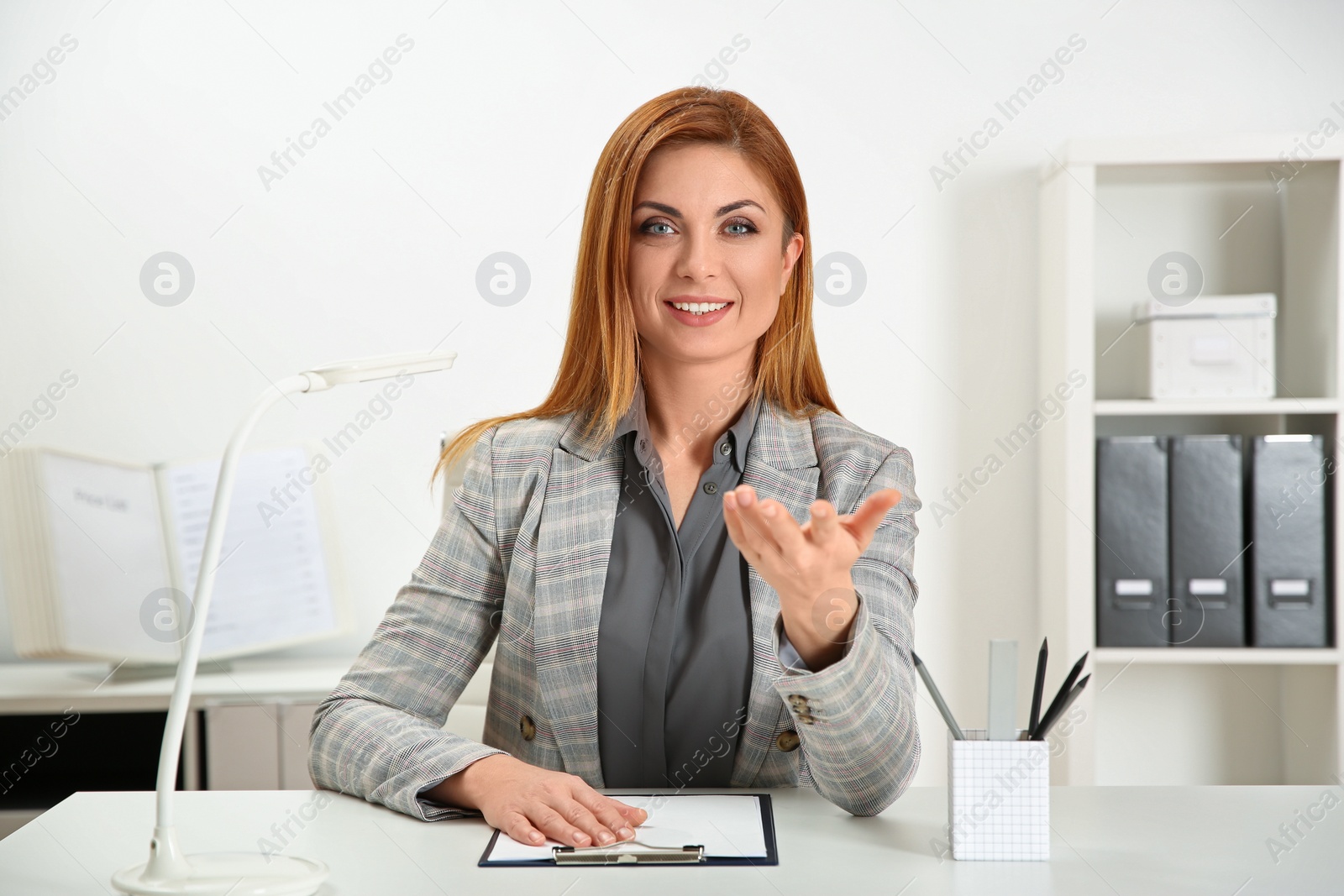 Photo of Happy woman using video chat in modern office, view from web camera