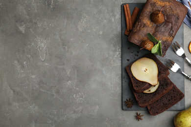 Flat lay composition with tasty pear bread on grey table, space for text. Homemade cake