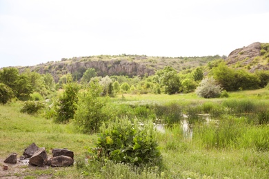Photo of Beautiful landscape with beautiful pond and rocky hill. Camping season