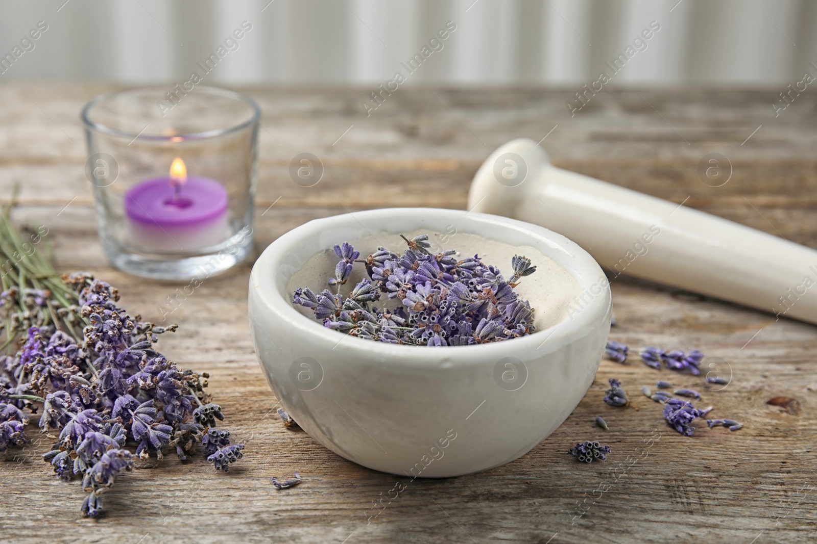 Photo of Mortar with lavender flowers on table. Ingredient for natural cosmetic