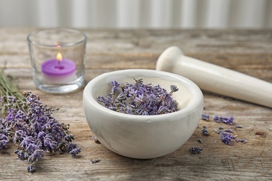 Mortar with lavender flowers on table. Ingredient for natural cosmetic
