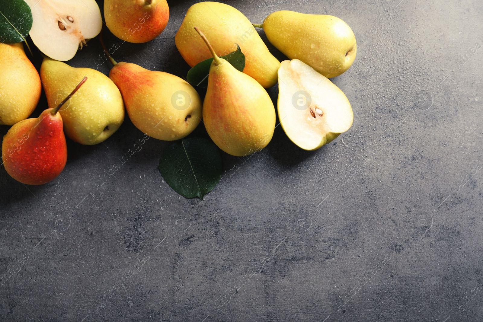 Photo of Ripe pears on grey background, top view. Space for text