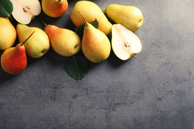 Ripe pears on grey background, top view. Space for text