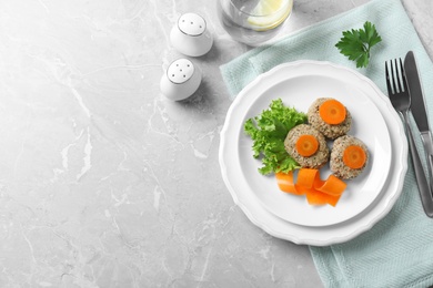 Flat lay composition with plate of traditional Passover (Pesach) gefilte fish on grey background. Space for text