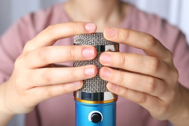 Photo of Woman making ASMR sounds with microphone, closeup