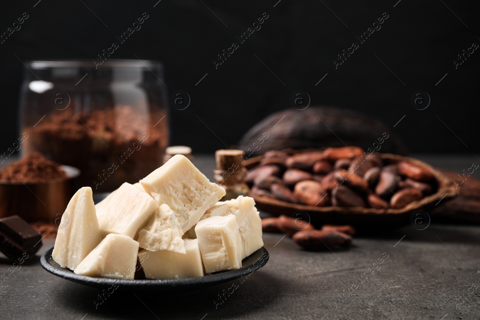 Photo of Organic cocoa butter in plate on grey table