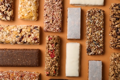 Photo of Flat lay composition with protein bars on color background