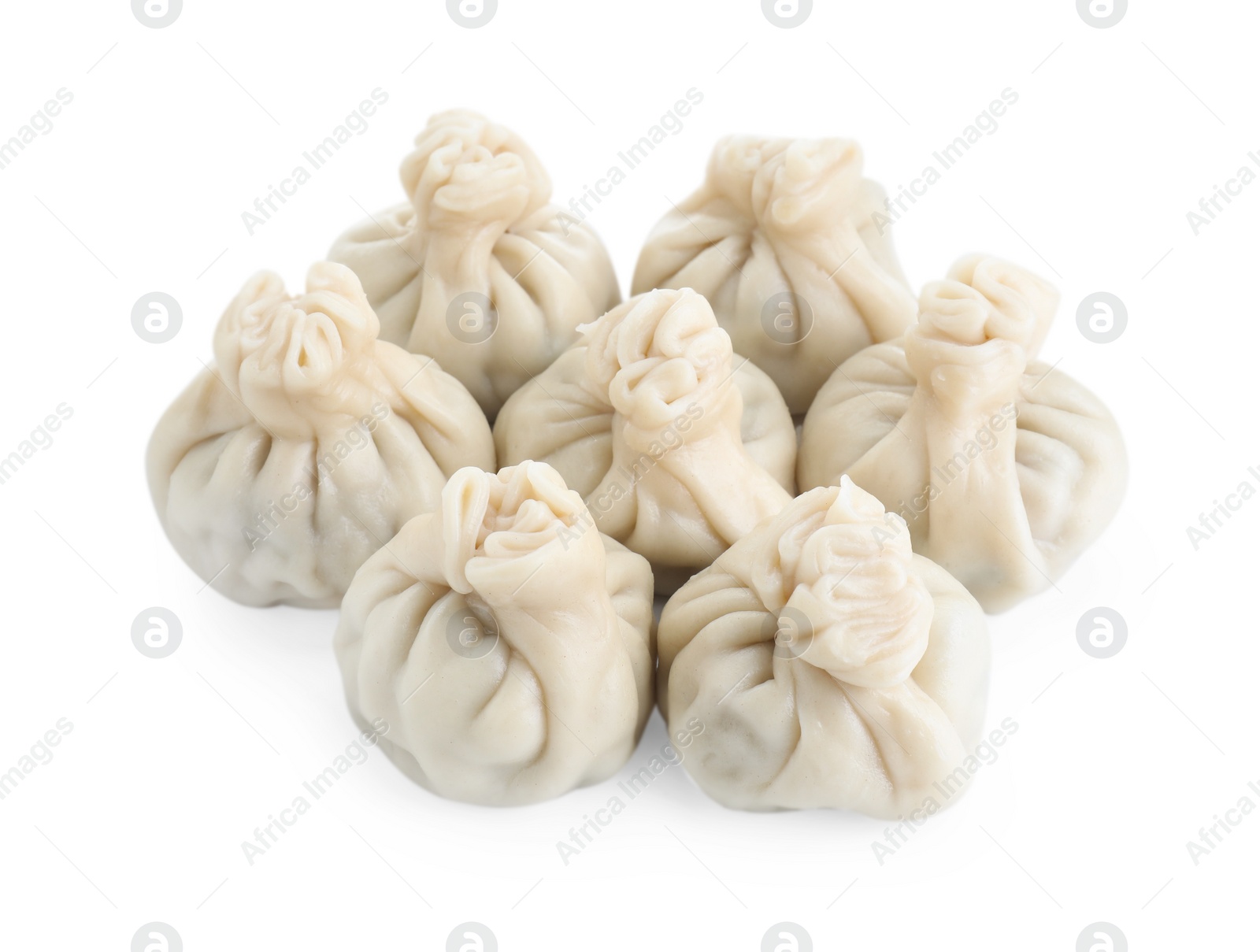 Photo of Many tasty khinkali (dumplings) isolated on white. Georgian cuisine