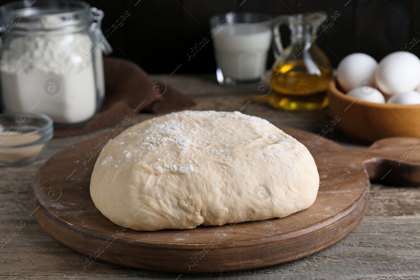 Photo of Fresh yeast dough and ingredients on wooden table