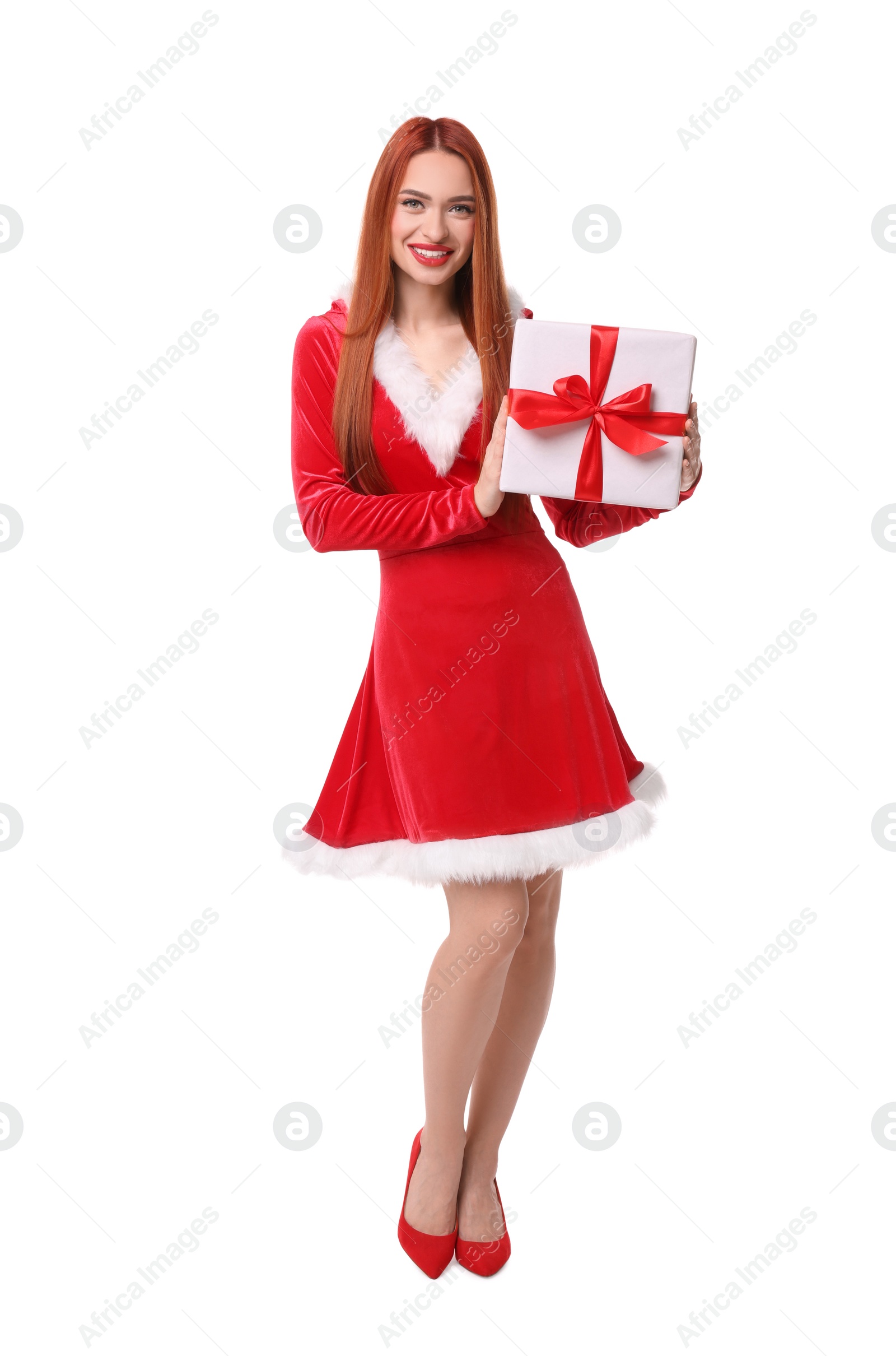 Photo of Young woman in red dress with Christmas gift on white background