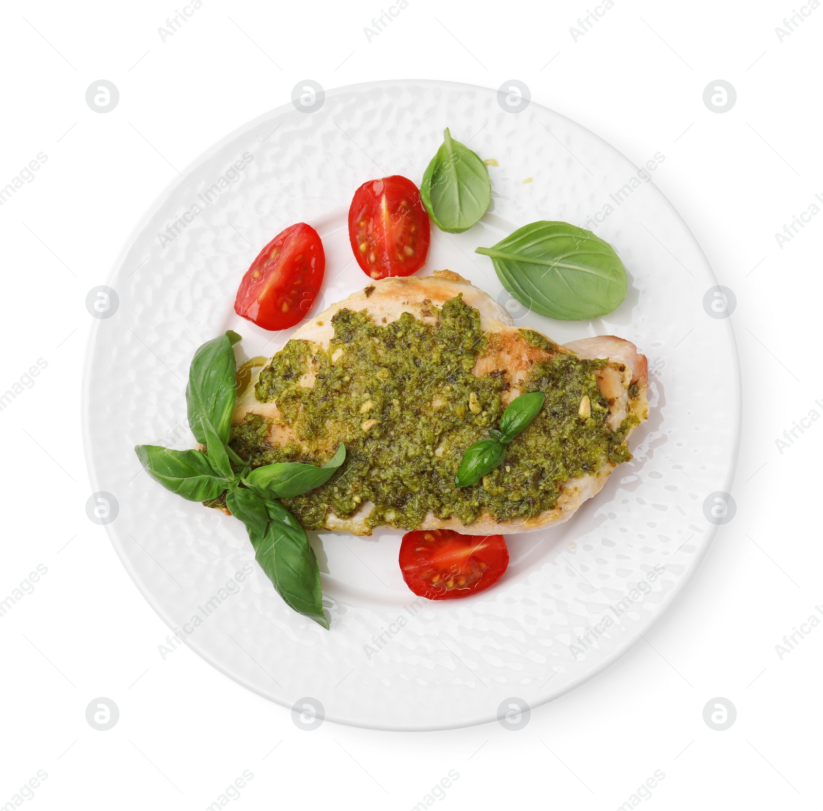 Photo of Delicious chicken breast with pesto sauce, tomatoes and basil isolated on white, top view