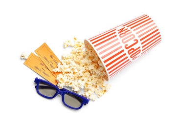 Photo of Bucket of fresh popcorn, tickets and 3D glasses on white background, top view. Cinema snack