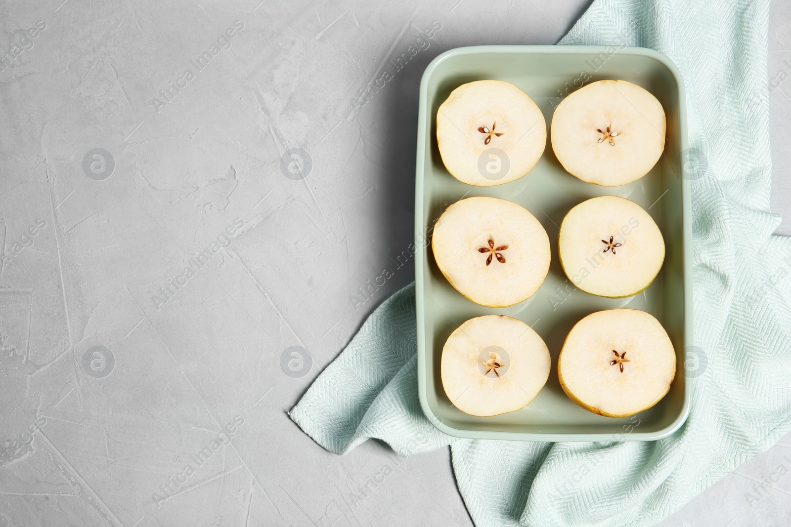 Photo of Flat lay composition with sliced fresh ripe pears and space for text on gray background