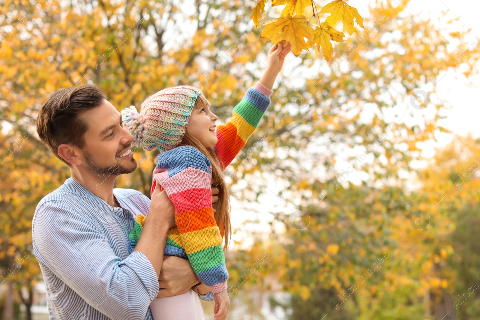 Photo of Father and his cute daughter spending time together in park. Autumn walk