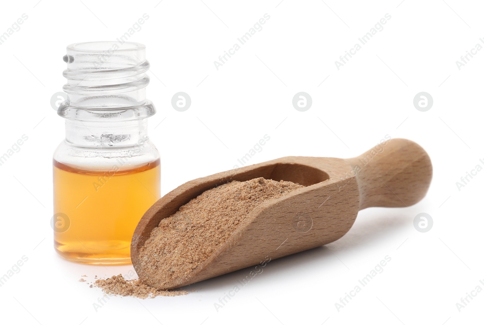 Photo of Bottle of cinnamon oil and scoop with powder on white background