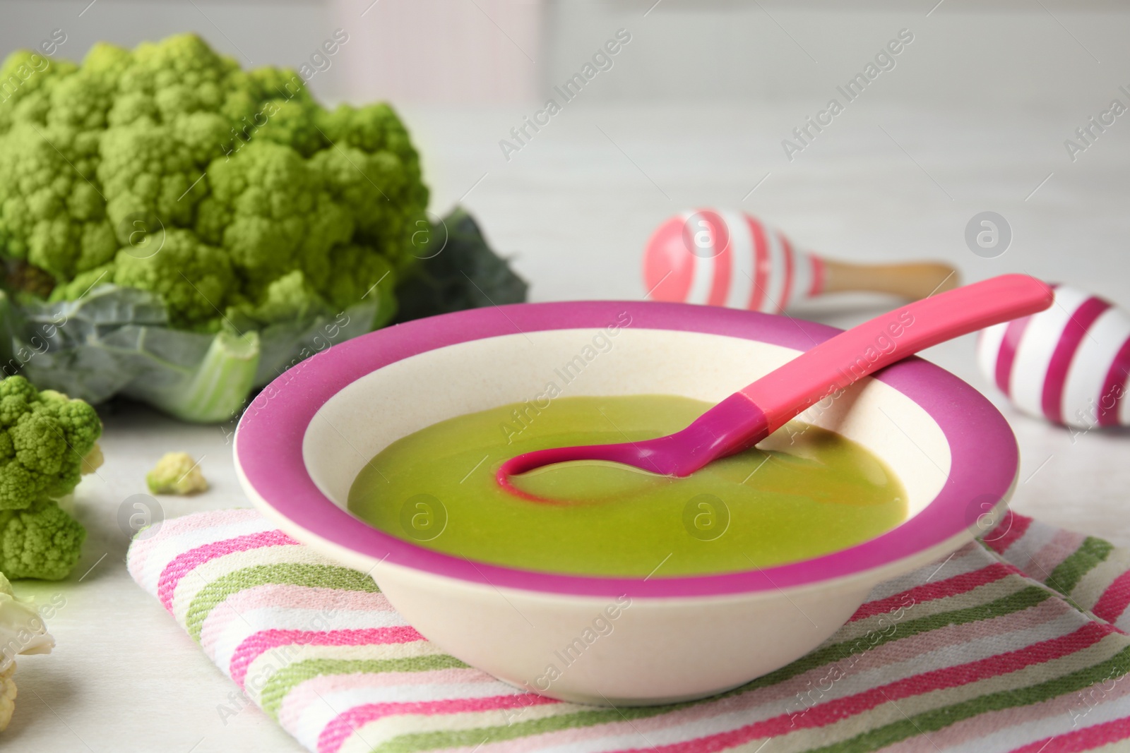 Photo of Plate with healthy baby food on light table