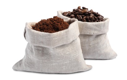 Bags with ground coffee and roasted beans on white background