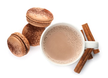 Mug with delicious hot cocoa drink and macarons on white background, top view