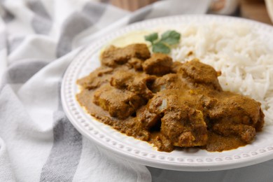 Photo of Delicious chicken curry with rice on table, closeup