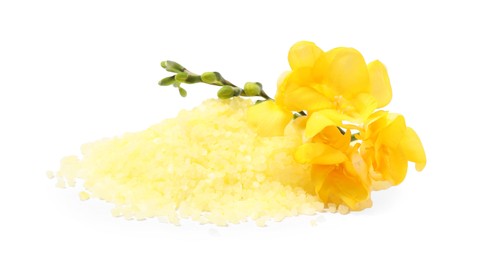 Photo of Yellow sea salt and flowers isolated on white