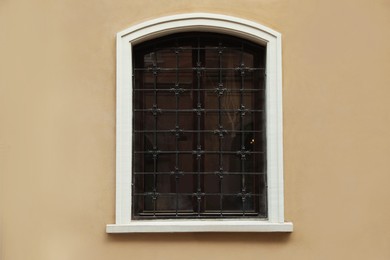 Photo of Beautiful arched window with grills in building outdoors